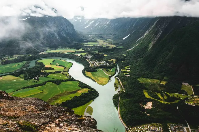 green grass field and river