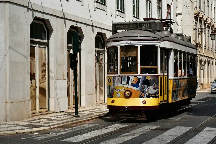 yellow and white tram on road during daytime