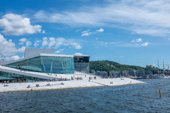 people sitting and walking near body of water