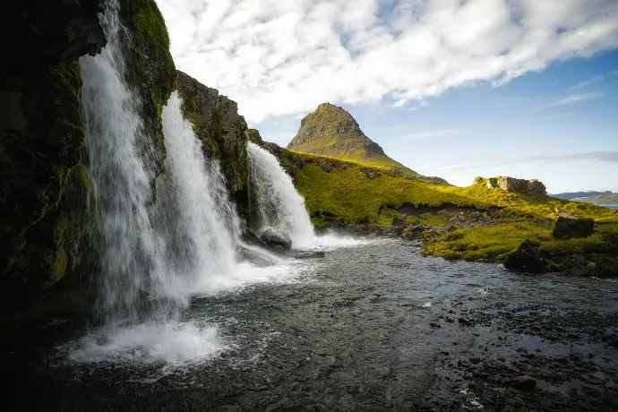 a waterfall with a rainbow